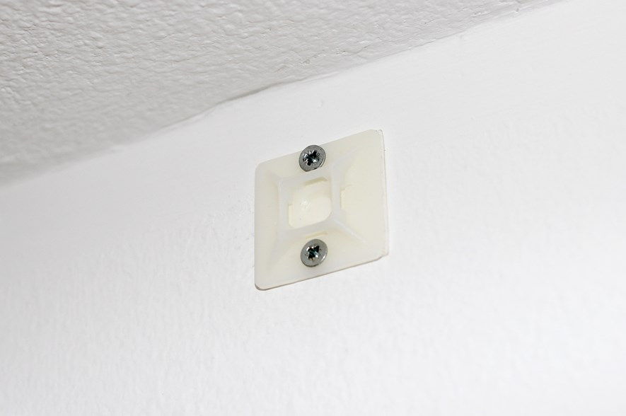 The cable tie mount on the wall.